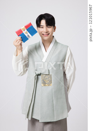Portrait of a young man wearing hanbok and holding a luxury gift certificate Portrait of a young man wearing hanbok and holding a luxury gift certificate 121015967
