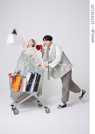 A Korean man wearing a hanbok and shopping with a shopping cart and a foreign woman carrying shopping bags A Korean man wearing a hanbok and shopping with a shopping cart and a foreign woman carrying shopping bags 121016120