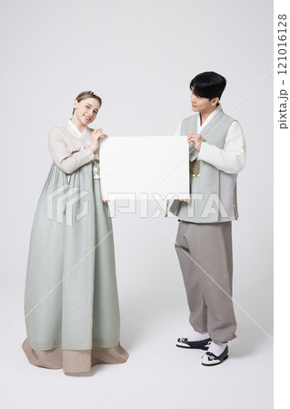 A foreign woman and a Korean man wearing hanbok, standing side by side and holding white copyspace 121016128