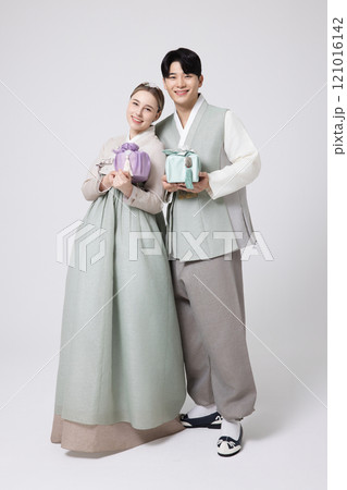 A foreign woman and a Korean man wearing hanbok and holding carefully prepared gifts A foreign woman and a Korean man wearing hanbok and holding carefully prepared gifts 121016142
