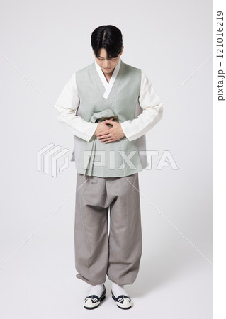 A young man wearing a hanbok, standing with the correct posture and greeting people A young man wearing a hanbok, standing with the correct posture and greeting people 121016219