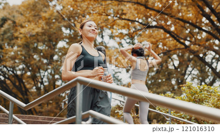 Happy, stairs and running with Japanese woman in city for health, athlete and fitness exercise. Wellness, cardio and training with person on steps in Japan outdoors for workout, sports and marathon Happy, stairs and running with Japanese woman in city for health, athlete and fitness exercise. Wellness, cardio and training with person on steps in Japan outdoors for workout, sports and marathon 121016310