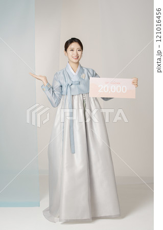Portrait of a beautiful woman standing holding a shopping coupon while wearing an elegant and elegant hanbok Portrait of a beautiful woman standing holding a shopping coupon while wearing an elegant and elegant hanbok 121016456