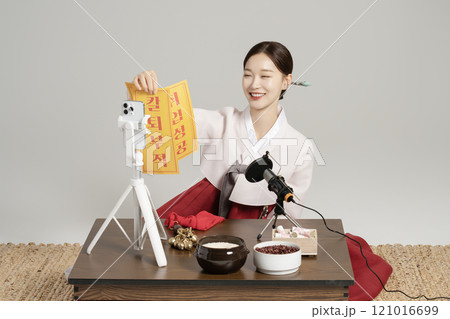 A young shaman doing a live broadcast while showing an amulet. A young shaman doing a live broadcast while showing an amulet. 121016699