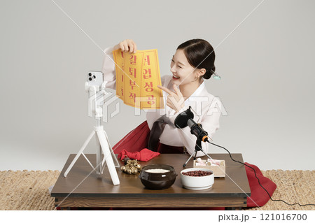 A young shaman doing a live broadcast while showing an amulet. A young shaman doing a live broadcast while showing an amulet. 121016700