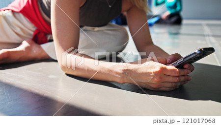 Phone, stretch and dancer typing in studio for networking, communication or contact with app. Hands, warm up exercise and person preparing for rehearsal or practice with cellphone for online routine. 121017068