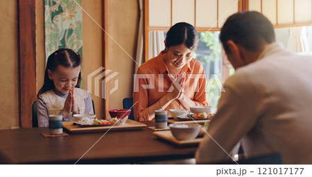 Japanese family, pray or food with dinner tradition for faith, gratitude or bow together at home. Mother, father or daughter with thankful culture or respect for meal, snack or eating at dining table 121017177