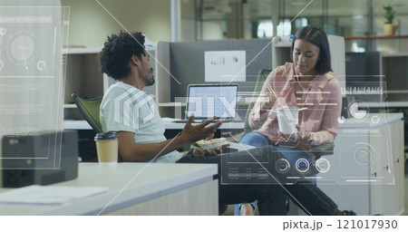 Image of financial data processing over diverse colleagues discussing work in office 121017930