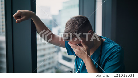 Stress, man and doctor in hospital with healthcare mistake, crisis or fail in treatment plan. Upset, burnout and male medical worker crying with grief for patient loss in surgery at clinic in Japan. 121018031