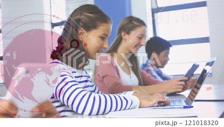 Students using laptops in classroom with data analysis image over them 121018320