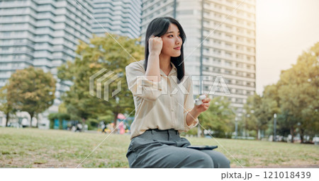 City, woman and earphones for music, relax and streaming podcast with wireless technology. Japanese girl, outdoor and listening to audio online, sound and thinking of jazz playlist on radio at park 121018439