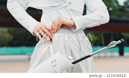 Arrow, gear and person with outdoor archery training, target practice and professional Japanese athlete. Setup, belt and archer with sports challenge, getting ready and equipment at kyudo club 121018918