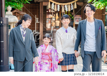神社で七五三のお祝いをするファミリー 121019014
