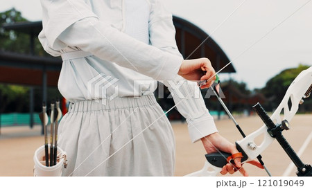 Hands, ready and bow for training, archery and preparing for competition, equipment and outdoor for game. Contest, athlete and practice from tournament, skills and challenge for person in Japan Hands, ready and bow for training, archery and preparing for competition, equipment and outdoor for game. Contest, athlete and practice from tournament, skills and challenge for person in Japan 121019049