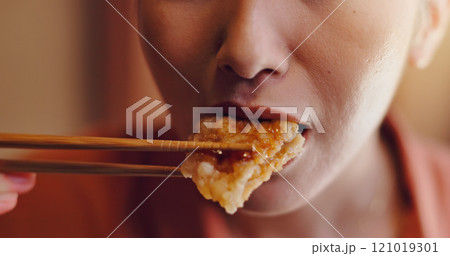 Person, mouth or bite with chopsticks for eating, hungry snack or taste for delicious meal or protein at home. Japan, closeup or food with wooden or bamboo utensils for tradition, culture or heritage Person, mouth or bite with chopsticks for eating, hungry snack or taste for delicious meal or protein at home. Japan, closeup or food with wooden or bamboo utensils for tradition, culture or heritage 121019301
