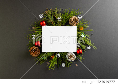 Christmas decorations with white card and copy space on black background 121019777