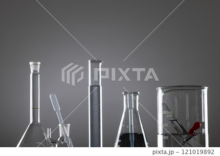 Close up of laboratory dishes and copy space on grey background 121019892