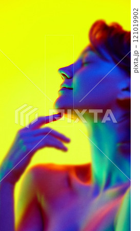 Contemporary art collage. Neon hues surround female face, with eye and cheekbone in crisp focus. Communication and social issues concept. Contemporary art collage. Neon hues surround female face, with eye and cheekbone in crisp focus. Communication and social issues concept. 121019902