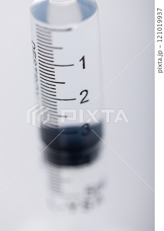 Vertical image of close up of laboratory syringe and copy space on grey background Vertical image of close up of laboratory syringe and copy space on grey background 121019937
