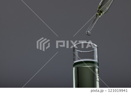Vertical image of close up of laboratory test tube and pipette with copy space on grey background Vertical image of close up of laboratory test tube and pipette with copy space on grey background 121019941