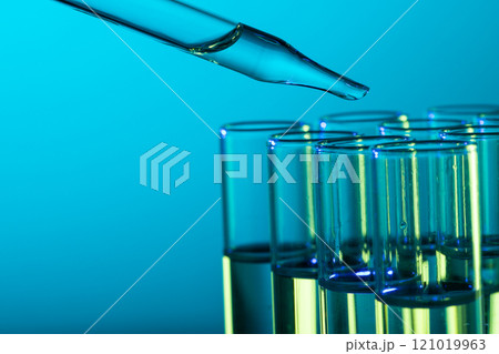 Close up of laboratory test tubes and pipette with copy space on blue background 121019963