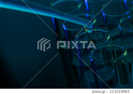 Close up of laboratory test tubes and pipette with copy space on blue background 121019965