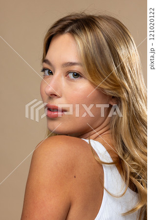 Portrait of caucasian woman wearing natural makeup on beige background 121020122