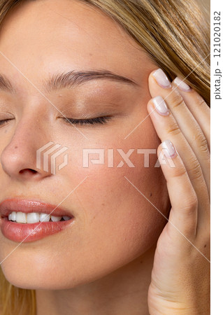 Close up of caucasian woman wearing natural makeup and beige nail polish Close up of caucasian woman wearing natural makeup and beige nail polish 121020182