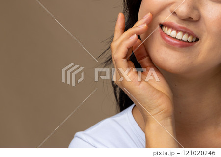 Asian woman wearing natural makeup and white t-shirt on beige background, copy space 121020246