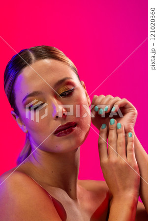 Caucasian woman wearing red lipstick and blue nail polish on pink background Caucasian woman wearing red lipstick and blue nail polish on pink background 121020360