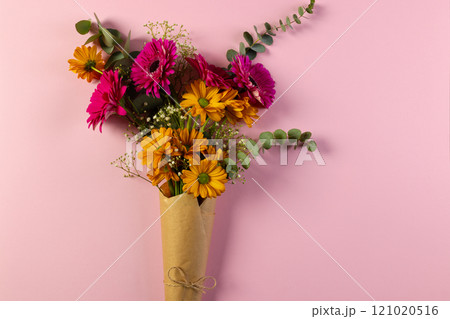 Bunch of pink and yellow flowers in paper with copy space on pink background 121020516