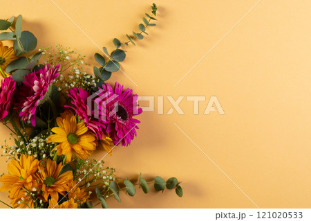 Bunch of pink and yellow flowers with copy space on yellow background Bunch of pink and yellow flowers with copy space on yellow background 121020533