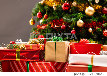 Presents and christmas tree with baubles, decorations and copy space Presents and christmas tree with baubles, decorations and copy space 121020645