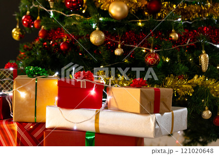 Presents and christmas tree with baubles, decorations and copy space Presents and christmas tree with baubles, decorations and copy space 121020648