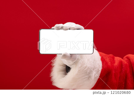 Santa claus holding smattphone with copy space on red background Santa claus holding smattphone with copy space on red background 121020680
