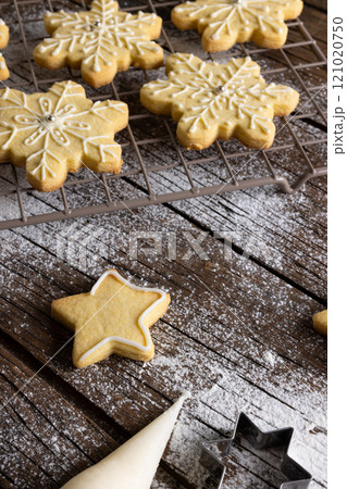 Vertical image of close up of christmas cookies with flour and copy space on wooden background 121020750