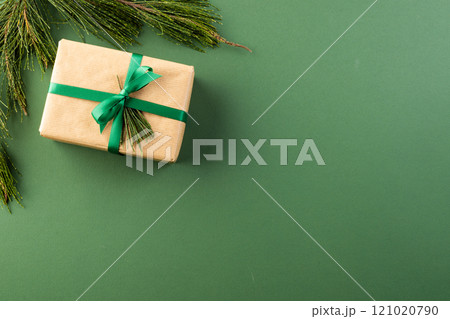 Christmas presents with green ribbon and copy space on green background Christmas presents with green ribbon and copy space on green background 121020790