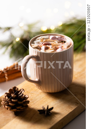 Vertical image of mug of chocolate and marshmallows and christmas decorations with copy space 121020807