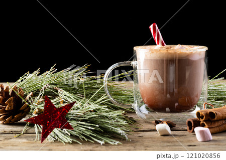 Glass mug of chocolate and marshmallows and christmas decorations with copy space Glass mug of chocolate and marshmallows and christmas decorations with copy space 121020856