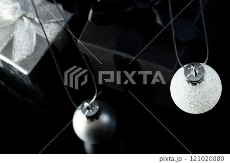 Elegant Christmas ornaments lie beside gift boxes, with copy space Elegant Christmas ornaments lie beside gift boxes, with copy space 121020880