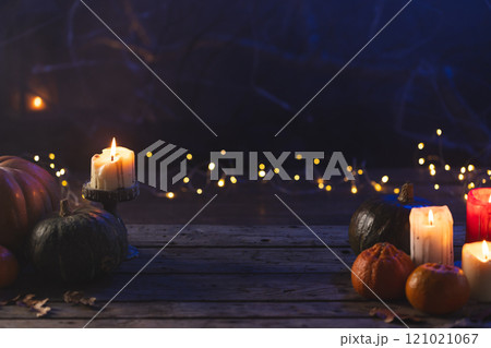 Pumpkins and dry leaves with copy space on dark background 121021067