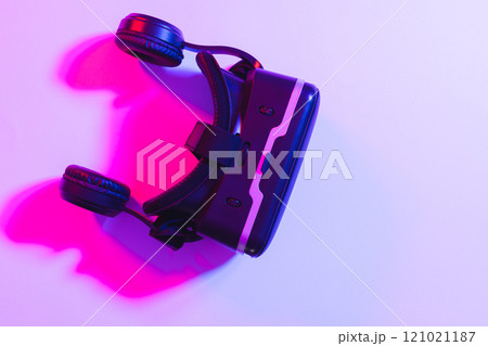 Composite of vr headset with copy space on neon background 121021187