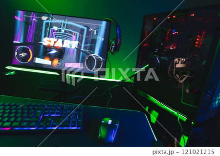 Composite of computer, keyboard with video game accessories with copy space on neon background 121021215
