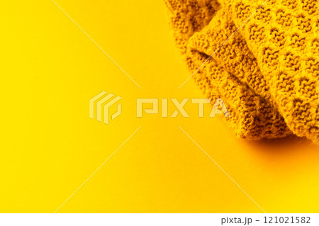 Micro close up of yellow wooly crochet fabric with copy space on yellow background Micro close up of yellow wooly crochet fabric with copy space on yellow background 121021582