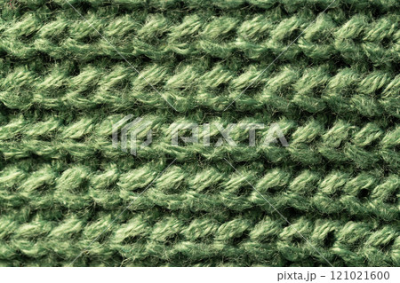 Micro close up of green wooly knitted fabric with copy space Micro close up of green wooly knitted fabric with copy space 121021600