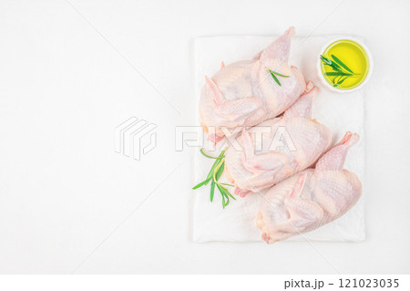 Fresh organic quails ready for cooking on a white background top view. copy space Fresh organic quails ready for cooking on a white background top view. copy space 121023035