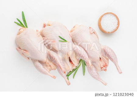 dietary quail meat on white table on a wooden board, top view dietary quail meat on white table on a wooden board, top view 121023040