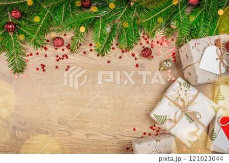 Christmas gift box, food decor and fir tree branch on wooden table. Christmas holiday card. top view. copy space 121023044