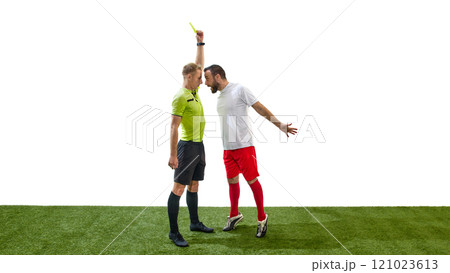 Young focused referee showing yellow card to emotional man, soccer player showing anger and arguing in disagreement isolated on white background 121023613