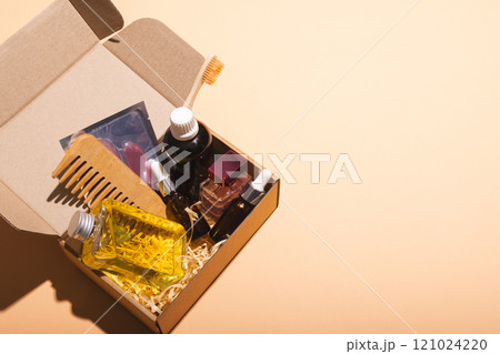 Box with beauty products and copy space over cream background 121024220